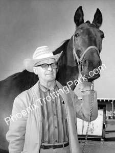 Man posing by horse in vintage photo